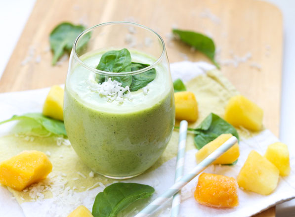 This tropical healthy green smoothie recipe made with spinach, pineapple, coconut, and mango is the perfect light summer breakfast!