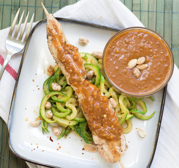 Zucchini noodles coated in a delicious peanut-sauce served with chicken skewers is a light and flavorful weeknight meal the whole family will love!