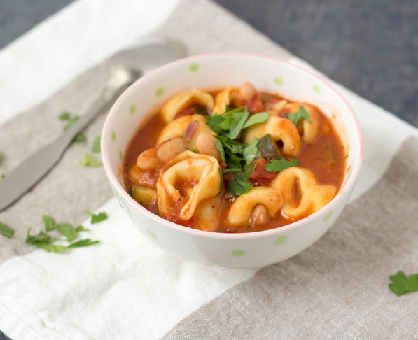 This simple 20-minute soup is perfect for a busy day! Cheese tortellini, white beans, zucchini, and Italian spices make for one tasty and family-friendly vegetarian dinner!