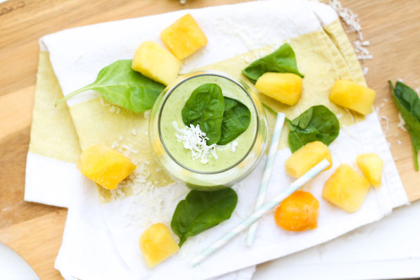 This tropical healthy green smoothie recipe made with spinach, pineapple, coconut, and mango is the perfect light summer breakfast!
