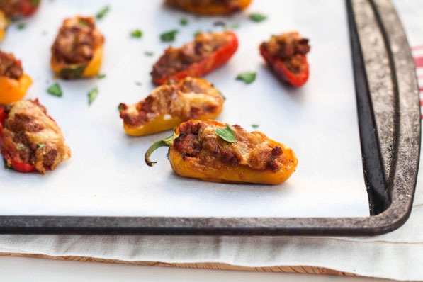 Taco pepper poppers are a fun mix between tacos and jalapeno poppers. Sweet mini peppers make this a flavorful family-friendly (non-spicy) option for dinner, snacks, or appetizers. Perfect healthy game-watching recipe!