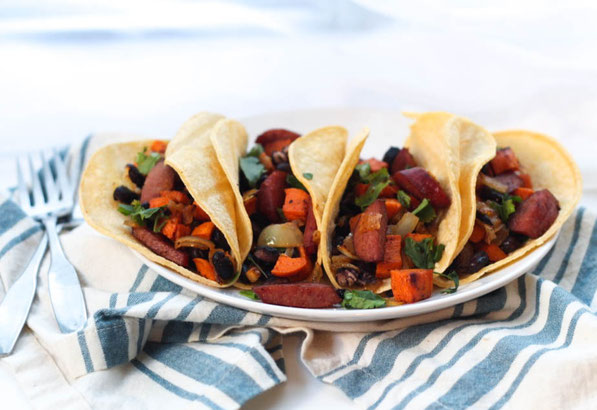 Sausage, sweet potato, onions, and black beans roast together  beautifully on a baking sheet to create the base of these delicious  (and gluten free) one-pan tacos for two!  