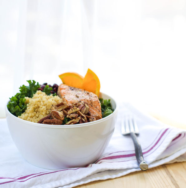 This colorful protein bowl recipe made with kale, salmon, quinoa, pecans, and cranberries is a protein-packed, fiber-filled healthy lunch that will keep you full and fueled all afternoon!