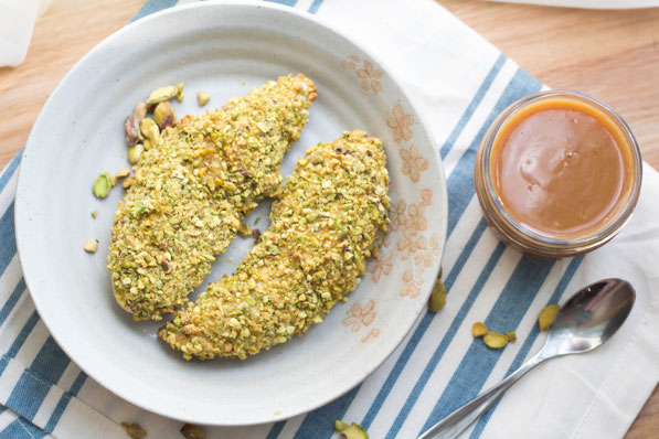 These healthy pistachio-crusted chicken tenders come together in just a few minutes, and the homemade BBQ honey-mustard dipping sauce is the perfect fun addition to this tasty dinner!