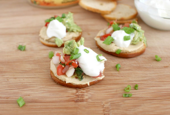 This is an easy recipe that's perfect for tailgating season! A few simple store-bought items come together in minutes to make these Southwestern hummus bites. Everyone will love this tasty, healthy snack!