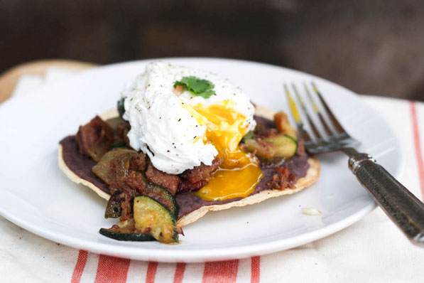 These tasty tostadas with beef, zucchini, black beans, and a poached egg are a tasty way to turn last night's beef dinner into a delicious high protein breakfast! 