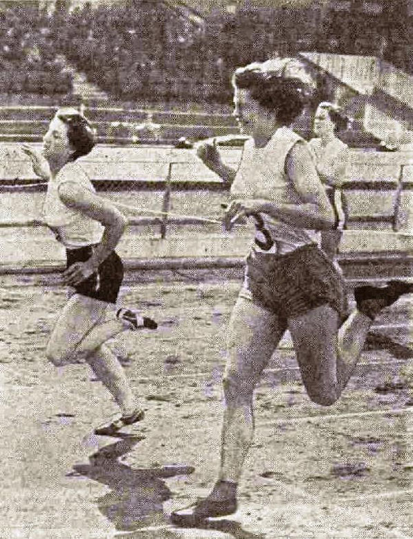 Pat Devine (on left) wins the 220 yards final from Miss B. Foster during the 1955 Caledonian Games at White City, London. Elspeth Hay is seen finishing 3rd.