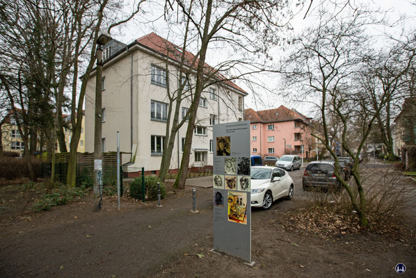 Links das Wohnhaus Rheingoldstraße 32 (das helle Gebäude) und die Gedenkstele rechts.