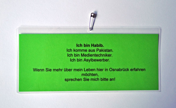 Laminated identification badge (green), 8 × 21 cm, with safety pin, 2014