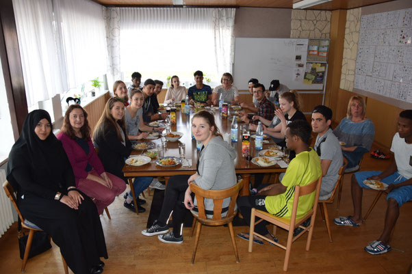 Schüler des BvS und junge Geflüchtete mit Mitgliedern des Flüchtlingshilfevereins beim gemeinsamen Essen