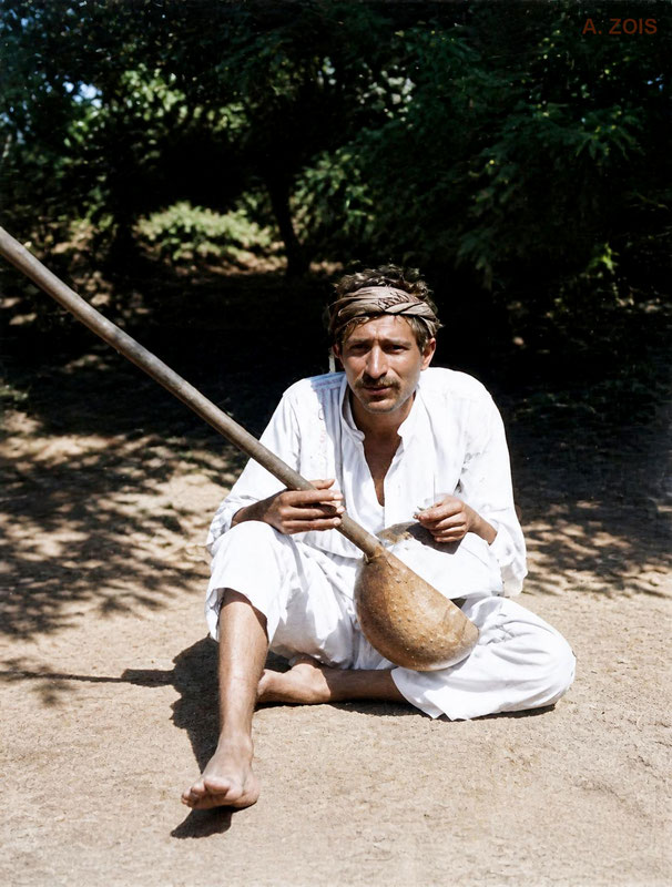 1922 : Poona, India. Meher Baba playing an Indian instrument outside his thatched hut. Image rendering by Anthony Zois. BP
