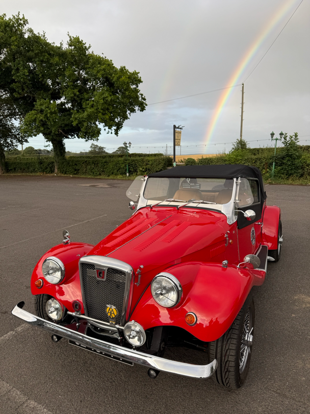 Beautiful car in front of a rainbow
