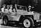 Admiral Chester William Nimitz (c), the Commander-in-Chief of the US Pacific Fleet, takes a ride around Pearl Harbor with his aides-de-camp in a willys jeep 