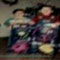 We see: 6-7 year old Kevin in a red shirt and denim overalls sitting on a pink bike of some sort with Joe in green and white by his side.