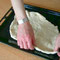 preparing pizza dough on baking tray