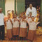 Students with uniforms with Mr. Seidu (center) and another teacher