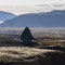 Strýtur in glistening midday light with the ice mass of Langjökull behind