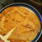 small corn quesadilla w/ Miso dressing on top and hot sauce inside.