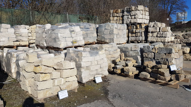 Mauersteine und Naturmauersteine auf Paletten gelagert