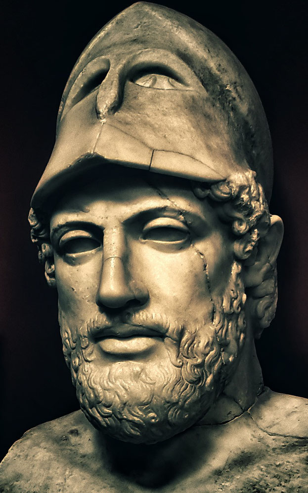 Close-up of a marble bust depicting a bearded man wearing a Corinthian helmet pushed back on his head, with visible cracks and strong facial features.