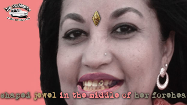 Photo of Mrs. Chopra, an indian lady with a diamond shaped jewel on her forehead and a gold tooth. 