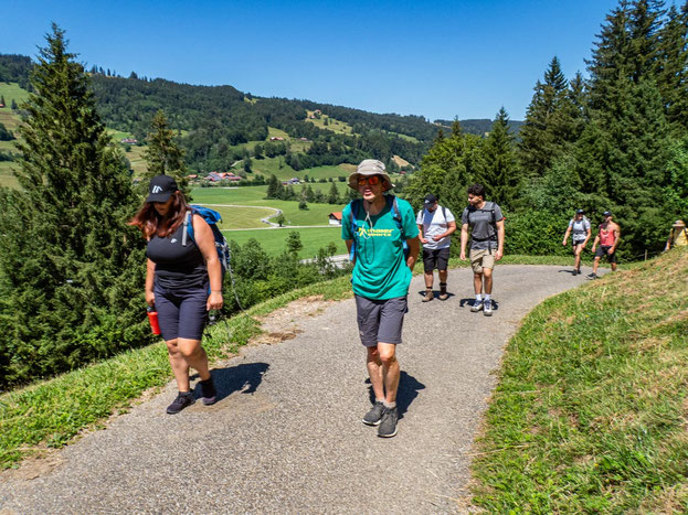 Gruppe des Integrationsprojekts Wanderglück beim gemeinsamen Aufstieg zur Alpsee-Bergwelt im Allgäu auf einem steilen Wanderweg.