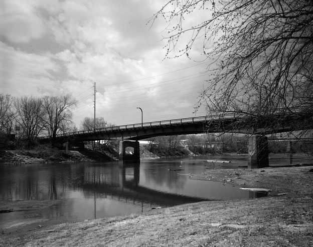 View of the Benton Street Bridge from the west bank of the Iowa River, looking northeast