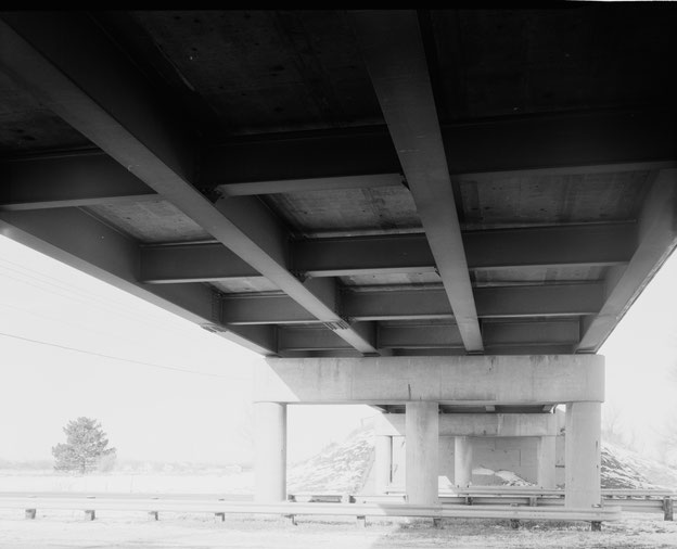 Underside of overpass, showing piers, beams, lateral bracing and deck underside. View to north. 