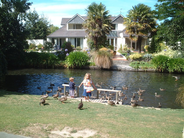 クライストチャーチの公園の水辺で鳥にえさをあげている子供　名古屋にもこんな素敵な住宅街が有ればいいのに・・・