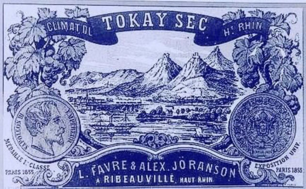 L. Favre & Alex Joranson . Une des toutes premières étiquettes de vin d'Alsace ( vers 1860) met en scène les trois châteaux de Ribeauvillé, les montagnes et les moyens de transports modernes : train et vapeur sur le Rhin 