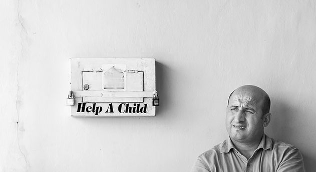 help a child sign and a middle aged man with a grimace.