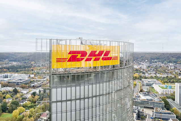 The DHL emblem is emblazoned on the Post Tower in Bonn. The name Deutsche Post remains on the back of the building until further notice - company courtesy.