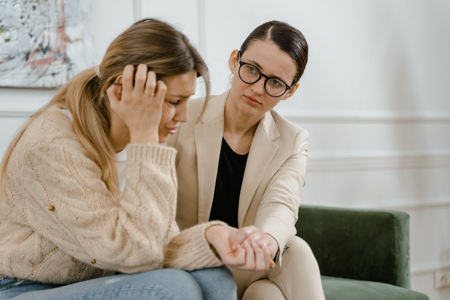 A Christian counselor holding a patient’s hand