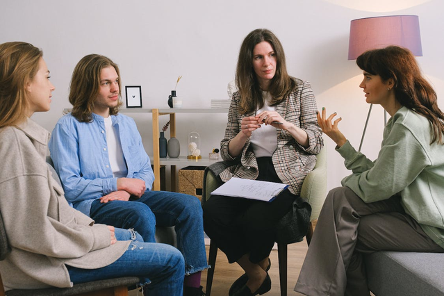 People speaking during group therapy for addiction recovery