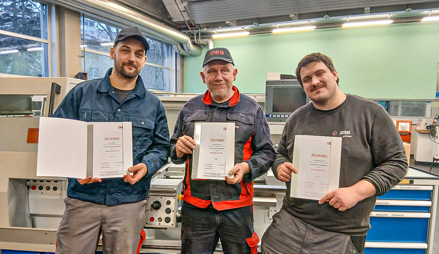 Absolventen mit Lehrabschlusszeugnis in der Hand