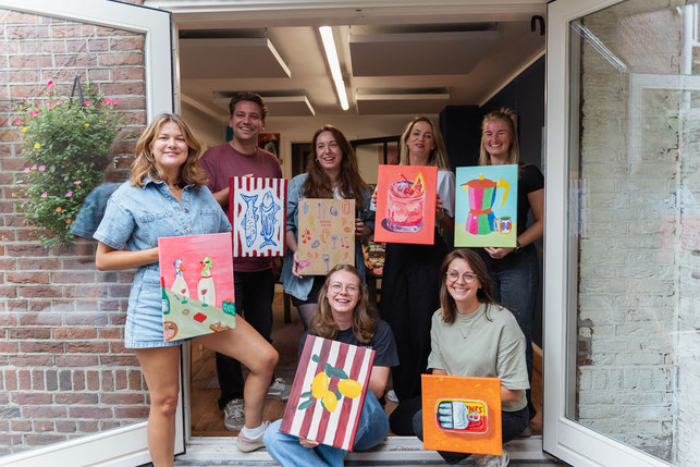 Gezellige vriendengroep laat trots hun vrolijke schilderijen zien. De resultaten van de Sip&Paint die zij als verjaardagscadeau en housewarming gift hebben gegeven aan elkaar. 