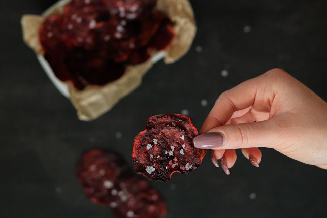 Rote Beete Chips in einer Hand gehalten