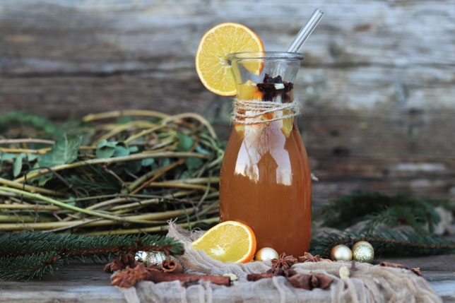 weißer Glühwein mit Orangensaft auf einem Tisch