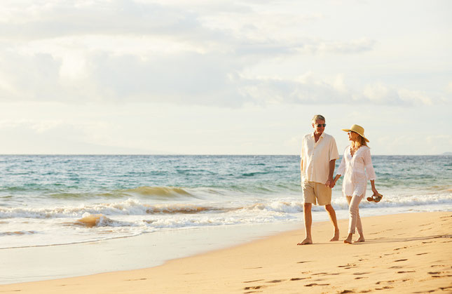 Couple walking on beach thanks to a Fee Only Investment Management Firm in East Cobb