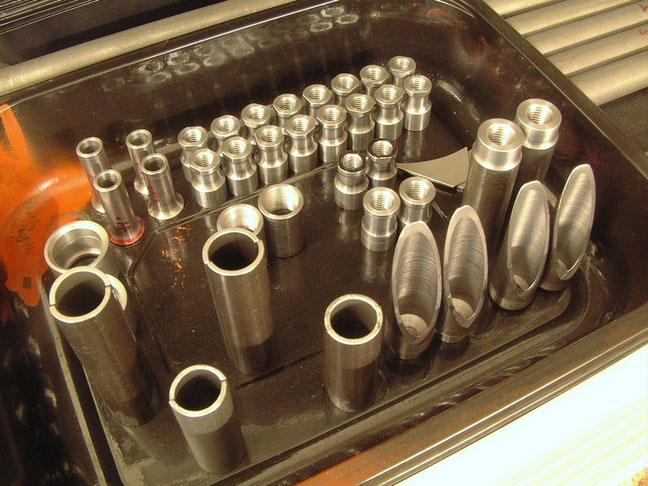 Machined bits prepared for fabrication of suspension arms