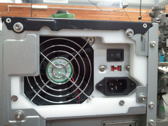 The replacement power supply for this computer has a non-standard mounting pattern and is very expensive. An adaptor/spacer was made from some 1/2" HDPE we had on hand so that a standard power supply could be used.