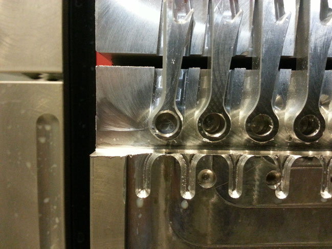 Part of the fixturing used on the horizontal mill. This is a soft jaw vice mounted on a multi sided rotating  "tombstone". The jaws have been milled to fit the parts so they can be held securely for an aggressive milling operation..