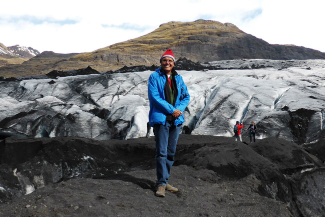 Standing in front of Sólheimajökull Glacier, in Iceland