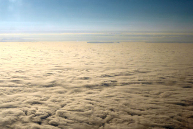 Icelandic mountains penetrating the clouds