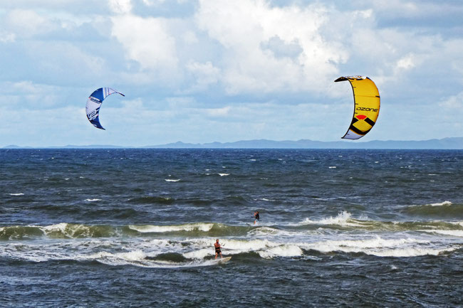 Kite surfers on Caloundra bar with Moreton Island behind