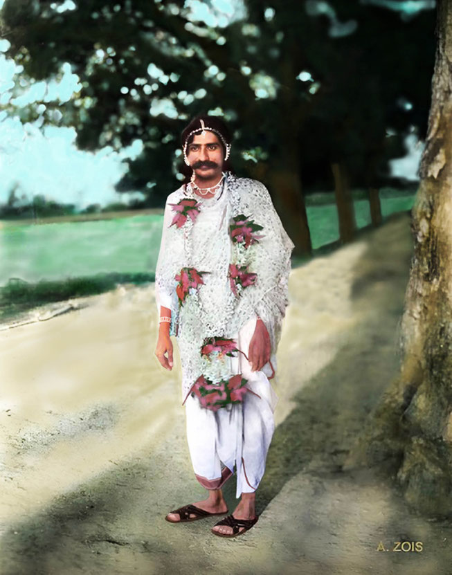 79.   1928 : Meher Baba with garland beside the Pravara River, Toka, India.