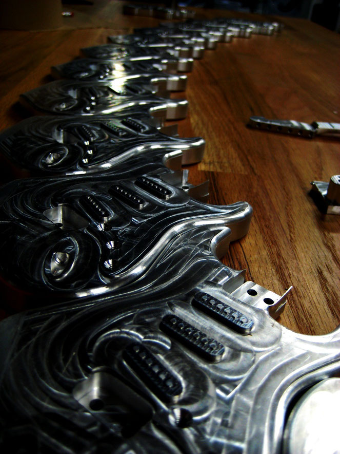 A nice array of small guitars machined from 6061 aluminum. Gene Giarratano and I made a bunch of these and had them anodized.