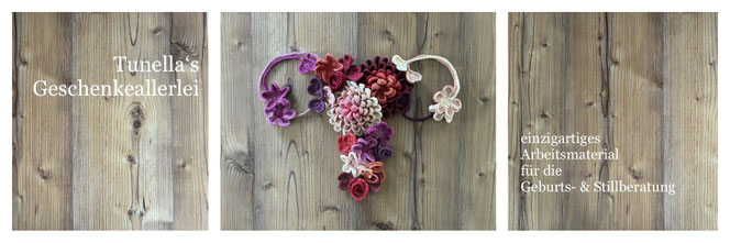 eine Gebärmutter wurde aus diversem Arbeitsmaterial für die Geburts- und Stillberatung (Muttermund-Blumen, Nabelschnurbändchen) wie eine Collage zusammengesetzt  