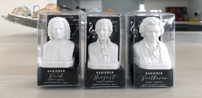 Three mini busts are erasers and all three are in their transparent box. From the left are Bach, Mozart and Beethoven. In the background is a decorative bowl.