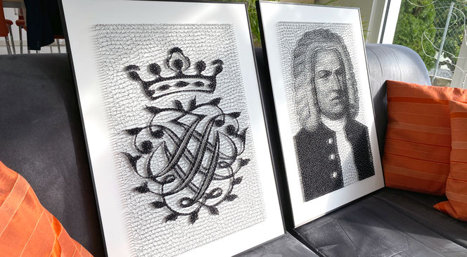 Two Bach nail pictures stand on a living room sofa. It is the Bach Seal and it is a Bach portrait. To the right of the works is an orange cushion, at the bottom you can see the seat of the sofa.